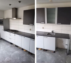 Moderne keuken met inbouwoven, hangkastjes en afzuigkap. - Foto 1